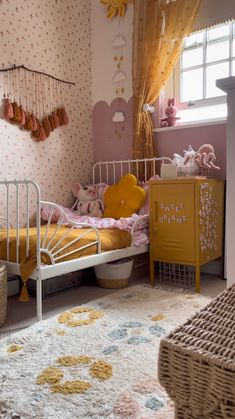 a child's bedroom with pink and yellow decor