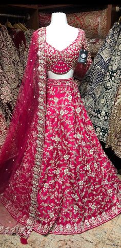 Cerise pink enhanced with pearl, diamonds stone & beads, sequence work highlighted in multi thread floral embroidery flared lehenga. Accomplished with similarly embroidered designer blouse and net dupatta. This pink lehenga is something extraordinary about the blend of ethnic fashion with contemporary details. Fabric: Raw Silk Size: 38/M Occasion: Wedding Ceremony or Reception WASH CARE INSTRUCTIONS - Please Dry clean only when it is applicable. Slight color variation is possible due to digital Pink Embellished Embroidered Fabric For Festive Occasions, Festive Pink Embellished Embroidered Fabric, Pink Kundan Embroidered Fabric For Wedding, Pink Embellished Embroidered Fabric For Diwali, Bollywood Style Embellished Pink Embroidered Fabric, Traditional Embellished Pink Choli, Pink Embroidered Fabric With Dabka Work For Reception, Embroidered Pink Fabric With Dabka Work For Reception, Pink Kundan Lehenga For Eid