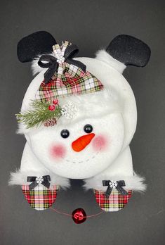 a white snowman with red nose and black ears