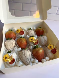 a box filled with chocolate covered strawberries and flowers