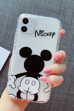 a person holding up a phone case with mickey mouse on it