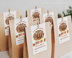 small brown paper bags with bundt bakery stickers on them are sitting on a table