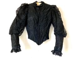 Antique Victorian bodice. Silk moire with Chantilly like lace overlay. Pointed front waist with stays and interior waist belt. Left side of bodice has pleats emanating from front opening placket. Puff sleeves and ruffled lace trim at neck and sleeve cuffs. Label reads "Mrs. J. xxxxxxxstadt Artistic DressmakerN Y".  Condition is good with some fading and light spots.  Measurements: waist 22" across front at underarms 16" shoulders 11-1/2" 7" across armhole length 16" - 19" at point sleeve 22" Victorian Fashion Women, Ruffled Sleeves, Lace Bodice, Lace Overlay, Mood Board Fashion, Jacket Style, Black Lace, Victorian Fashion, Lace Trim