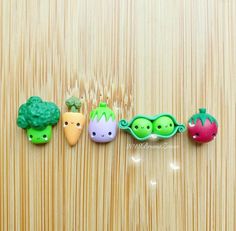 three broccoli, two carrots and one radish on a wooden surface