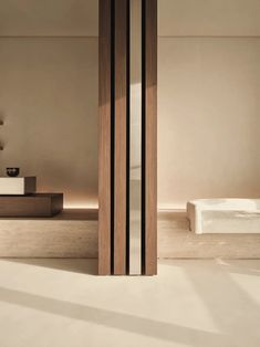 the interior of a modern bathroom with white walls and wood trimming on the doors