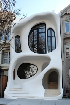 an unusual house with multiple windows on the outside