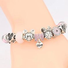 You can’t say you love Minnie Mouse if you don’t have one of these cute pink charm bracelets on your arm or in your jewelry box. These quality charms catch the light and steal the show in any room you enter. They are also removable which means that you can put them on another bracelet or jewelry piece and continue your slay. DIY your charm bracelet or mix and match, whatever the case create your very own unique style. Buy this bracelet to invest in your Disneyland drip or gift this luxury charm Cute Charm Bracelet With Removable Charms As Gift, Trendy Pink Friendship Charm Bracelet, Pink Themed Birthday Bracelets, Trendy Pink Charm Bracelet For Friendship, Themed Pink Bracelets For Birthday, Personalized Pink Novelty Charm Bracelet, Pink Charm Bracelets For Mother's Day, Pink Themed Adjustable Charm Bracelet, Adjustable Pink Friendship Charms