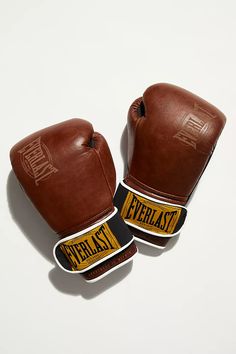 two brown boxing gloves sitting on top of each other