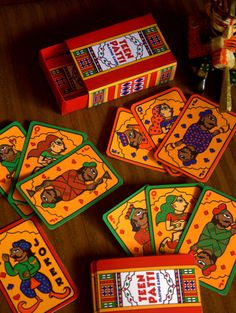 several colorful playing cards on a wooden table