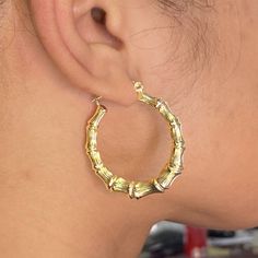 There is nothing more stylish than a pair of 10-karat Yellow Gold Bamboo Hoop Earrings. They're a versatile look that can be paired with any kind of outfit and are suitable for any occasion. The click-snap earring closures support a full hoop shape that is crafted in resilient, eye-catching 10k Yellow Gold. Its gold composition is tougher than most gold types, allowing it to withstand years of daily wear. These hoops measure 1.65 inches from side to side. Bamboo Hoop Earrings are a wonderful gif Clean Gold Jewelry, Bamboo Hoop Earrings, Nothing More, Shades Of Yellow, Pure Gold, 10k Gold, Pink And Gold, Gold Chains, My Jewellery