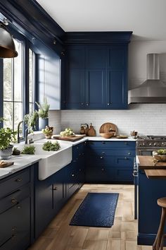 a kitchen with blue cabinets and wooden floors