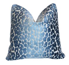 a blue and white pillow with an animal print pattern on the front, sitting on a white background