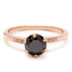 a rose gold ring with an oval black diamond in the center and white diamonds around it