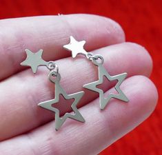 Stainless steel star charm and star stud earrings. These earrings are made of stainless steel only. Earring length: 30mm Charm material: stainless steel Earring stud material: stainless steel Backs: rubber This listing is for 1 pair of stainless steel star charm earrings. These earrings come in a gift bag. I offer combined shipping costs which give you a shipping discount for ordering multiple items from my shop. Please note: this item will be sent for free via standard unregistered post, withou Stainless Steel Star Charm Earrings For Gift, Star-shaped Stainless Steel Earrings For Gifts, Stainless Steel Star Charm Earrings Gift, Stainless Steel Star Earrings For Gifts, Star Shaped Stainless Steel Earrings For Gifts, Star Earrings Aesthetic, Stainless Steel Earrings Studs, Star Stud Earrings, Earring Stud