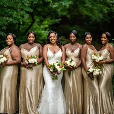 a group of women standing next to each other holding bouquets in their hands and smiling at the camera