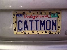 a license plate that says california cat mom with paw prints on the front and back