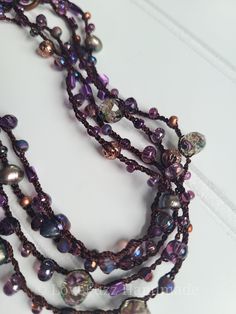 the beads are all different colors and sizes on this beaded necklace, which is attached to