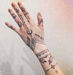 a woman's hand with tattoos on it