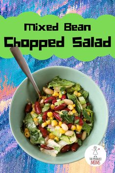 mixed bean chopped salad in a bowl with a spoon on the side and text overlay that reads, mixed bean chopped salad