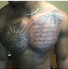 a man with tattoos on his chest has a message written in the upper half of his chest