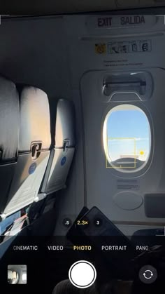 the view from inside an airplane looking out at the sky and through the window, there are two seats