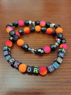 a bracelet with words on it sitting on top of a wooden table