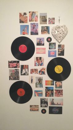 a white wall with several different records on it