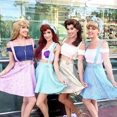 four women dressed in costumes posing for the camera