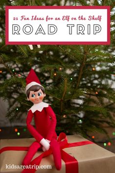 an elf sitting on top of a box next to a christmas tree with the words road trip