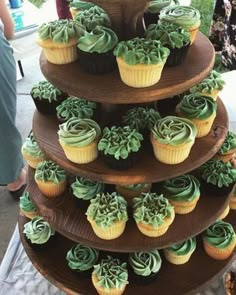 three tiered cupcake display with green frosting