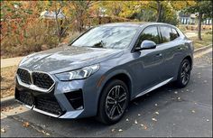 a grey bmw suv parked on the street