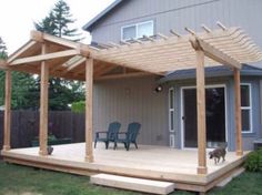 a wooden deck with two chairs and a pergolan