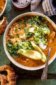 a bowl filled with soup and topped with avocado