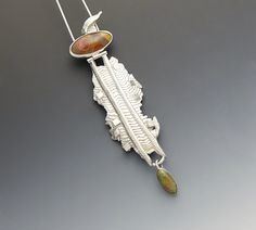 This is a very special piece and one of my favorites ever made.  Movement and dance were my inspiration for this Dancing Lady Pendant.  It was made from sterling silver and sterling silver cast in cuttlefish bone.  The stones were purchased at a Rock Shop in Roswell, NM.  I am unsure as to what kind of stones they are as I was going more for color and pattern.  As with most things I make, I have worn this pendant several times and always receive compliments on how it looks.  Because the upper hi Scrimshaw Sterling Pendant Jewelry, Eclectic Jewelry, Fish Pendant, Mixed Metal Jewelry, Colored Stones, Sterling Pendant, Casting Jewelry, Free Flowing, Pin Backs