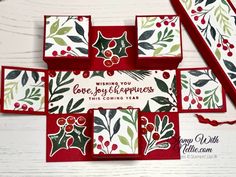 some cards with holly and berries on them