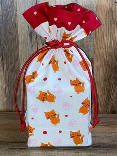 a small drawsack bag with foxes on it