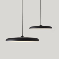 two black lamps hanging from the ceiling