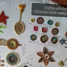 a table topped with lots of different types of beadwork on top of a white cloth