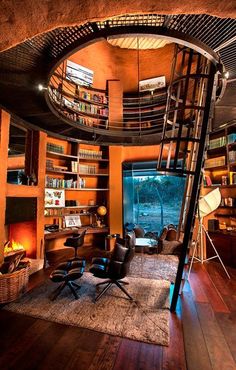 a spiral staircase in the middle of a living room with bookshelves and chairs