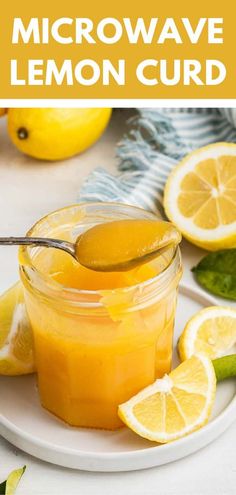 a spoon full of lemon curd sitting on top of a white plate next to sliced lemons