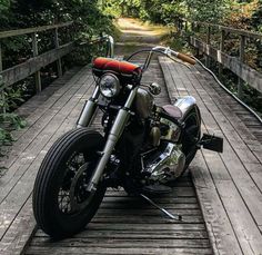 a motorcycle parked on top of a wooden bridge