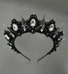 Luxurious black halo crown. Gothic black crown made of black light metal, crystal rhinestones and beads. This design of a black tiara will ideally look like a wedding crown, birthday crown, gothic crown, prom tiara. The evil queen crown height in the center is about 2 inches. The length of the earrings is about 2.35 inches. The length of the decorative part of the necklace is about 7.5 inches, the total length with the chain is 15 inches (2 inches of the extension chain). If you need to increase the length of the chain - let me know (it's free). You can see the necklace in detail at the link: https://www.etsy.com/listing/1338141417/black-necklace-any-color-rhinestones Crowns from the Exclusive Wedding Shop are always: * unique author's design * stunning detail * 100% handmade * light weigh Goth Wedding Crown, Gothic Wedding Tiara, Gothic Wedding Crown, Black Tiara Gothic, Black And Gold Crown, White Wedding Headband, Black Halo Crown, Gothic Tiara, Black And Silver Wedding