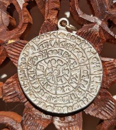 "This pendant is a sterling silver, 1.5-inch diameter replica of the original 6-inch clay disk discovered in 1908 at the archeological site of Phaistos palace in Minoan Crete, Greece. The clay disk is estimated to be several thousands of years old. The images stamped into the disk have been a source of mystery since its 20th-century rediscovery, with many competing theories and translation attempts.  The most-accepted theory of its meaning is that it is a symbolically-written record of a hymn of Ancient Engraved Round Pendant Jewelry, Ancient Style Round Silver Necklace, Ancient Style Silver Round Necklaces, Silver Ancient Style Necklace With Round Pendant, Silver Necklace With Vintage Round Pendant, Silver Necklace With Round Pendant In Vintage Style, Sand Dollar Pendant, Crete Greece, Ancient Artifacts