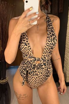 Introducing our Leopard Print Plunge One Piece Swimsuit, the perfect addition to your summer wardrobe! Designed with women in mind, this swimsuit is the epitome of style, comfort, and confidence. The plunging neckline and backless design offer a bold and daring look, while the wrap-around belt and adjustable tie provide a flattering and customizable fit. The cheeky bottom is both playful and flirtatious, making it perfect for lounging by the pool or hitting the beach with your friends. Crafted from a stretchy and durable fabric, this monokini is guaranteed to keep you comfortable and confident all day long. The leopard print adds a touch of exotic flair to your look, making you stand out from the crowd. So, whether you're planning a tropical getaway or simply soaking up the sun, this swims Summer V-neck One-piece Swimsuit, Summer V-neck Swimwear With Lined Body, Summer Backless One Piece With Lined Body, Summer Backless One-piece With Lined Body, Summer Backless One-pieces For Poolside, Summer Backless Swimwear, Summer Backless Bodysuit For Pool, Summer Backless One Pieces For Sunbathing, Backless Bodysuit For Beach Party