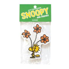 an air freshener snoopy and friends sticker on a white background with orange flowers