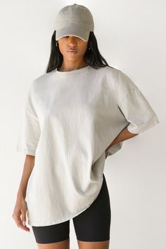 OVERSIZED BOYFRIEND TEE SILHOUETTE WITH DROPPED SHOULDERS. OUR HEAVYWEIGHT COTTON FABRIC IS VINTAGE-INSPIRED AND TIMELESS. IT GETS BETTER AND MORE WORN IN WITH EVERY WASH. JUST THE WAY YOU WANT IT. COLOR: FOG COTTON / WASHED BLACK COTTON SIZING: S/M (0-4), M/L (6-10) MODEL IS 5'8" AND WEARING A SIZE S/M FABRIC: 100% COTTON CARE: MACHINE WASH COLD WITH LIKE COLORS.CARE: TUMBLE DRY LOW. Solid Color Boxy Fit Crew Neck Top, Solid Boxy Fit Crew Neck Top, Solid Crew Neck Top With Boxy Fit, Relaxed Fit Shirttail Hem Top, Relaxed Fit Tops With Shirttail Hem, Basic Cotton Drop Shoulder Tops, Relaxed Fit Top With Shirttail Hem, Washed Tops With Shirttail Hem For Everyday, Relaxed Soft-washed Top With Shirttail Hem