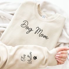 Custom Mama Sweatshirt with Dog Name on Sleeve, Personalized dog Mom Sweatshirt, Minimalist Momma Sweater, Christmas Gift for pet lover, Gift for Her This soft sweatshirt has a loose fit for a comfortable feel. With durable print, it will be a walking billboard for years to come. .: Loose fit .: 50% Cotton; 50% Polyester .: Medium fabric .: Sewn in label .: Runs true to size Care Instructions: Machine wash: warm; Non-chlorine: bleach as needed; Tumble dry: medium heat; Do not iron ; Do not dry clean Each Product is made to order just for you! For this reason, my shop does not offer exchanges, returns, or refunds. Please read over all details of the item before purchasing. This includes sizing, colors, processing/shipping times, shipping address, and all shop policies. If you run into any i Dog Mom Hoodie Ideas, Dog Mama Sweatshirt, Dog Mum Tshirt, Dog Mama Shirt, Cat Mama, Dog Mom Sweatshirt, Fur Mama, Pet Name, Long Sleeve Cotton T-shirt With Dog Print