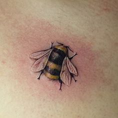 a bee tattoo on the chest