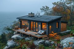 a small cabin on top of a cliff overlooking the ocean