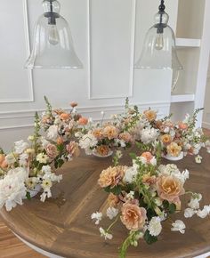 a wooden table topped with vases filled with flowers